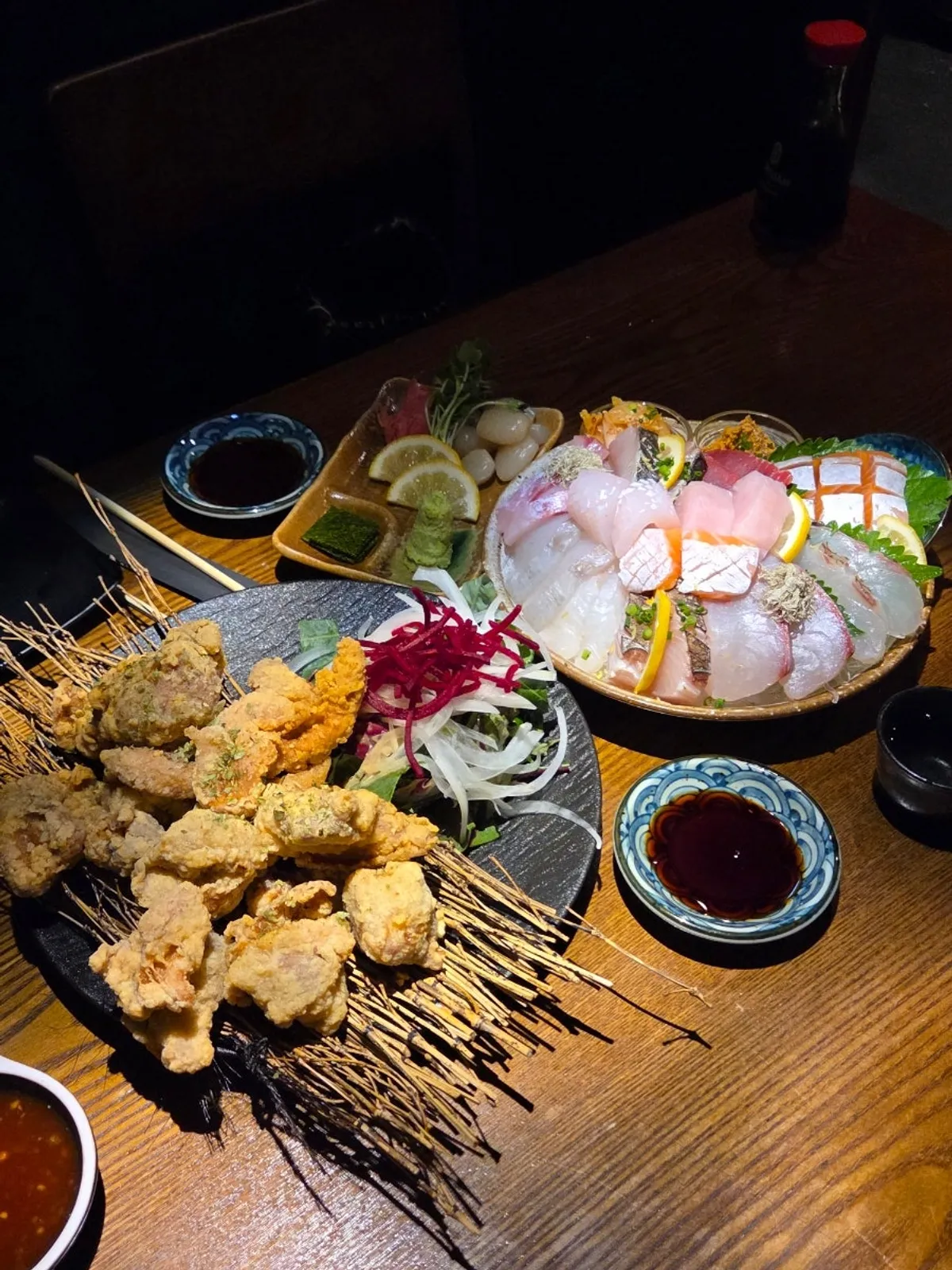 Table set with the two-person sashimi, tokkuri sake set, and fried sides