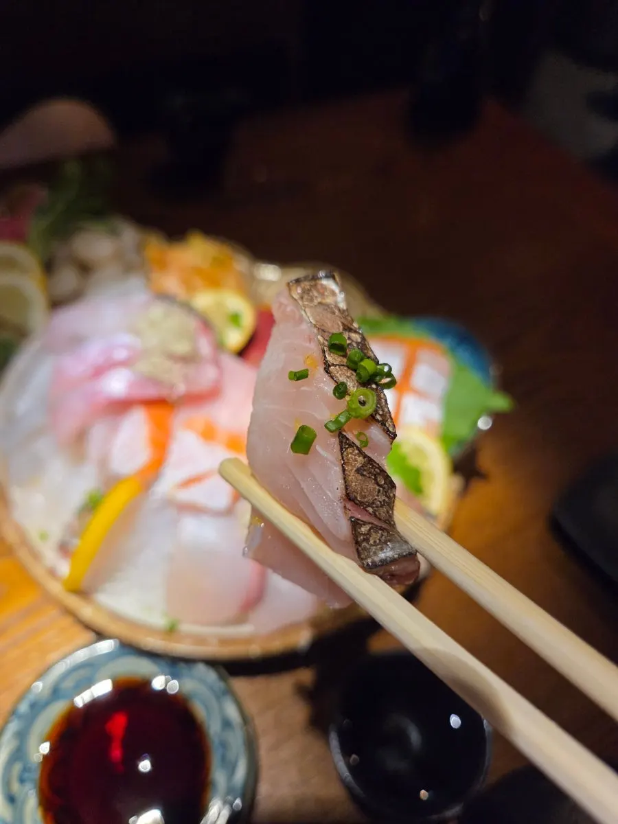 Sake in a tokkuri flask alongside the sashimi