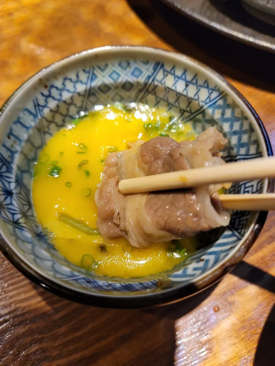 Sukiyaki beef dipped in egg yolk