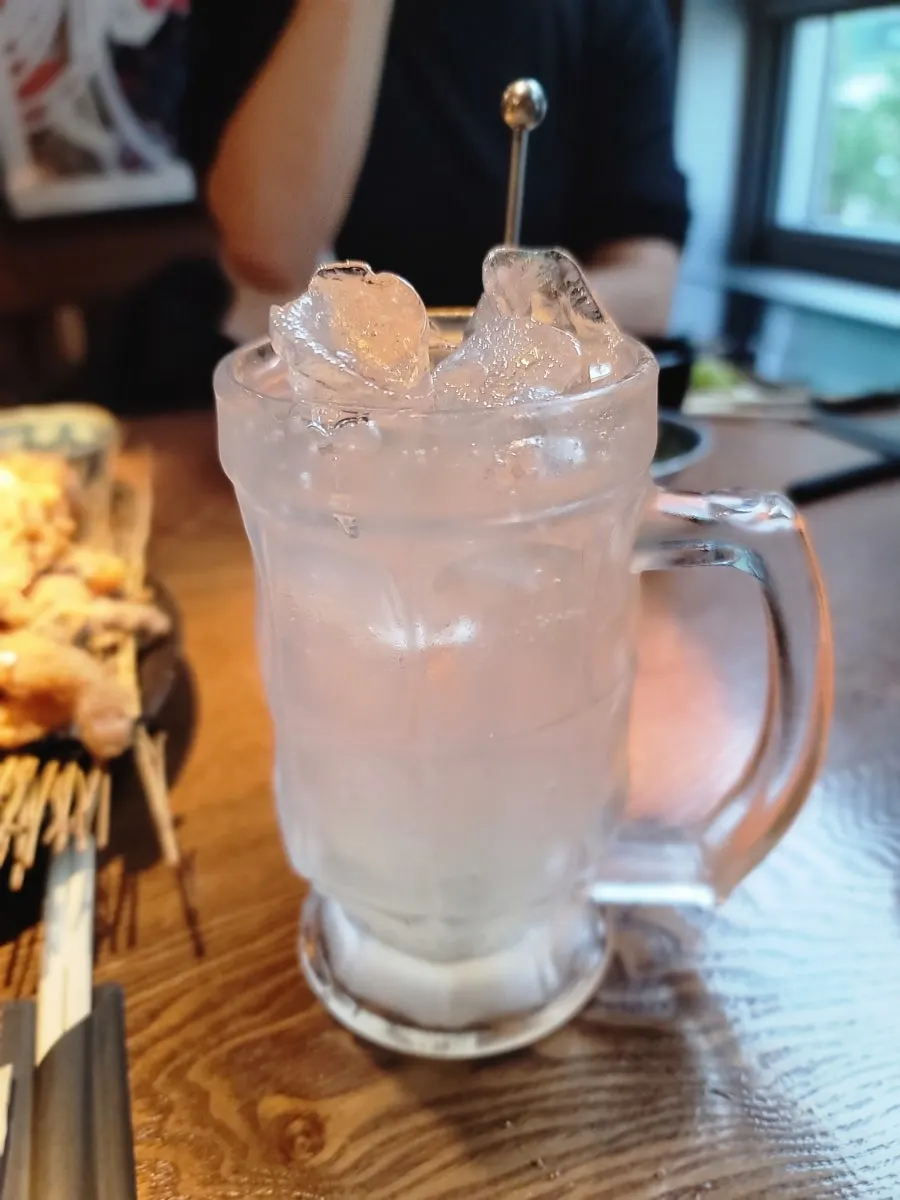 A yuzu highball and a glass of draft beer