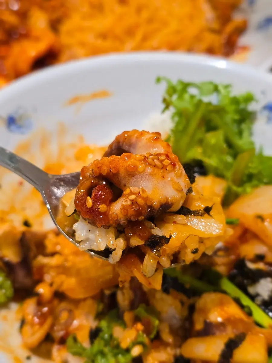 A spoonful of octopus over fluffy rice