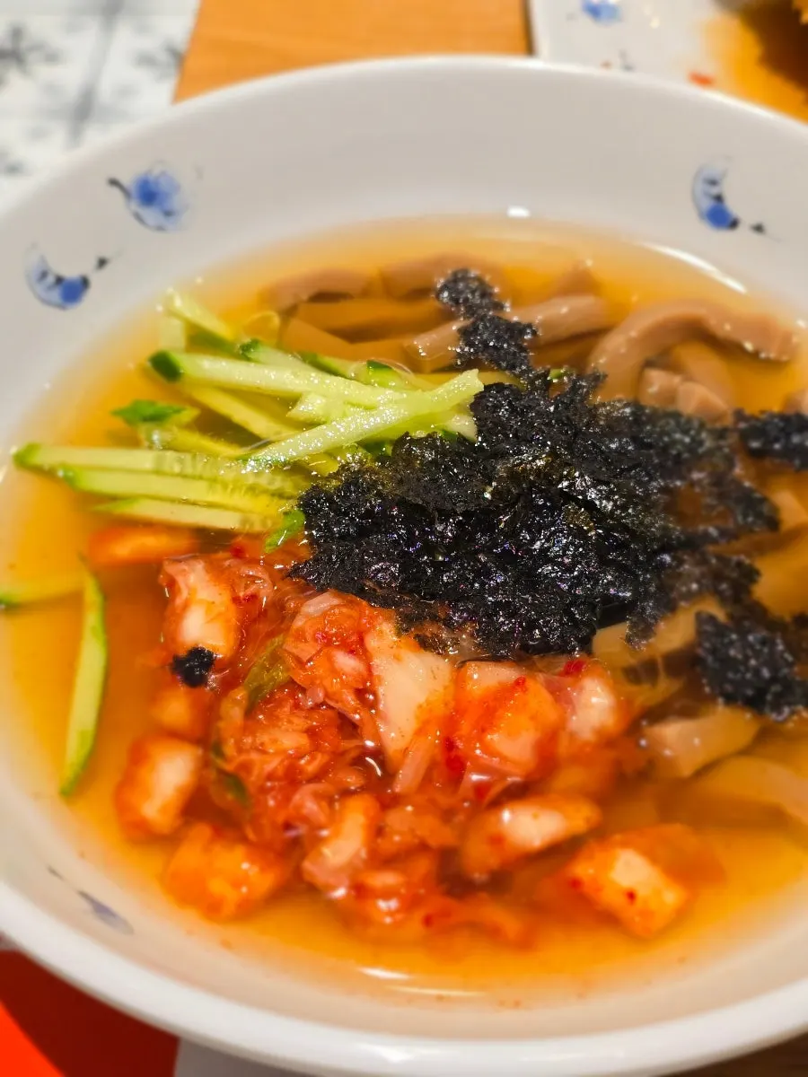 Close-up of mukbap topped with crunchy vegetables