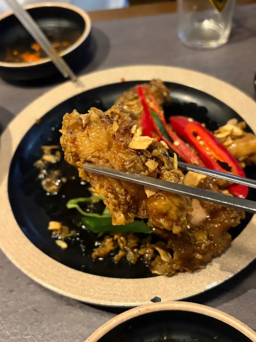 Cross-section of tender thigh-meat black garlic fried chicken