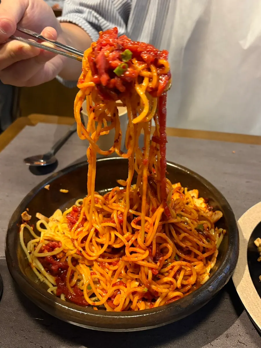 Generous portion of mixed spicy tartare bibim noodles