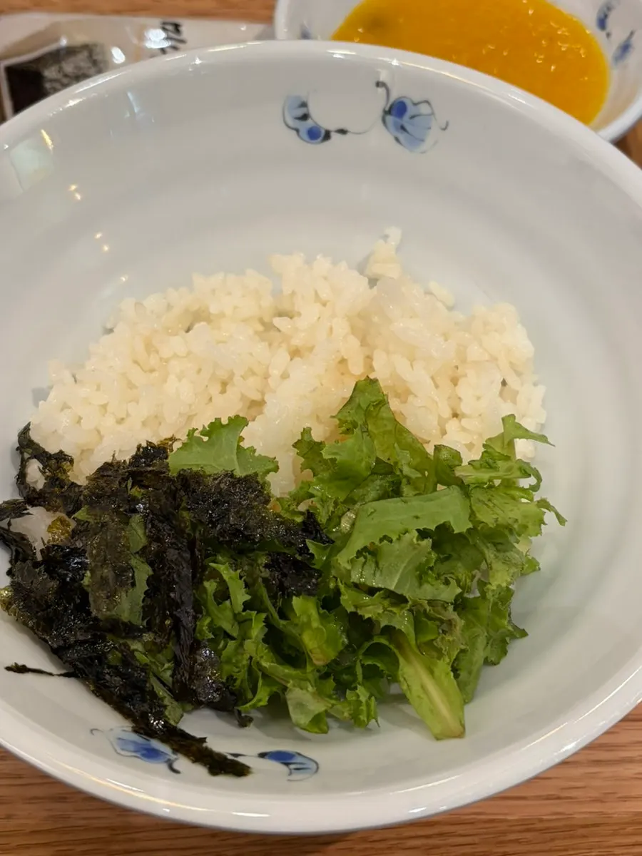 Bowl of rice revealed from under the stir-fry plate