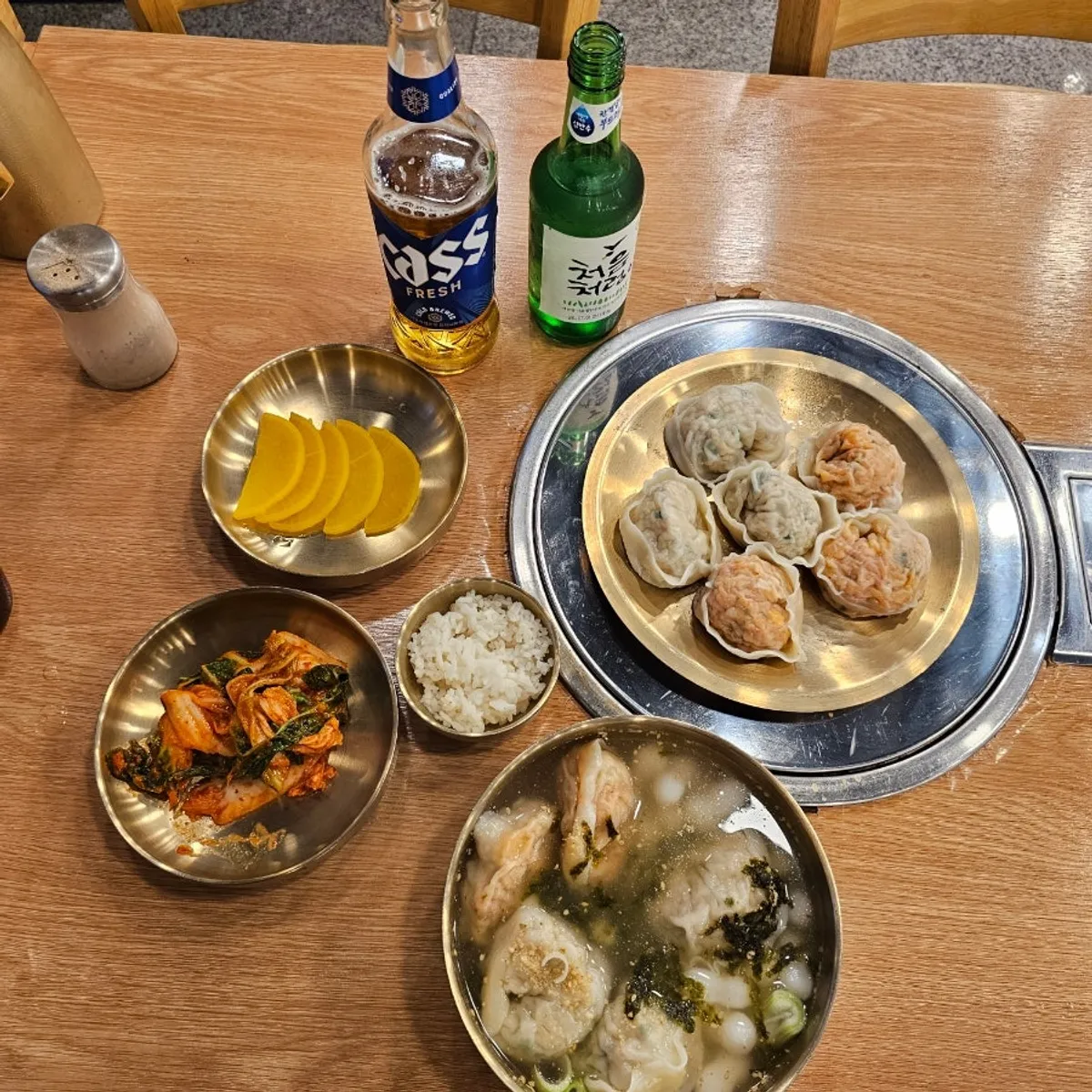 Full spread of Jongga Mandu's split-broth mandu hot pot