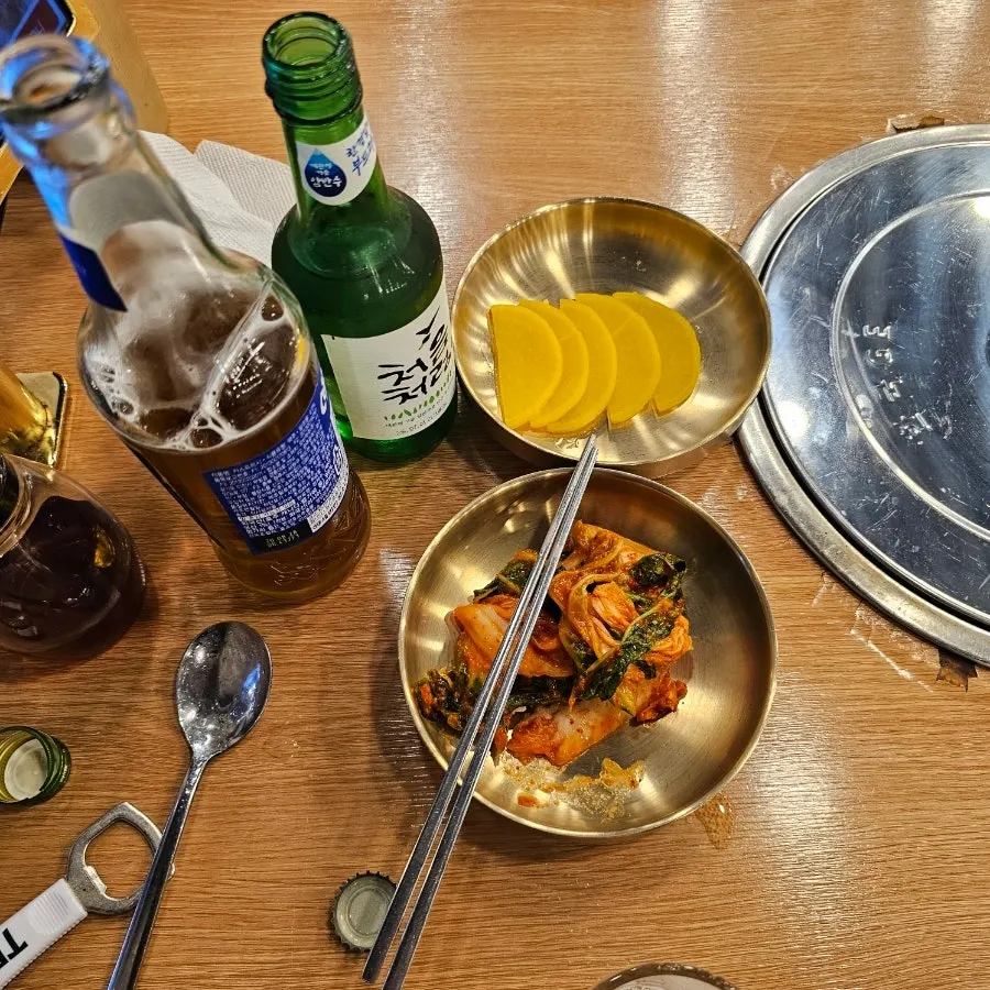 Basic side dishes and a bowl of rice served in brassware