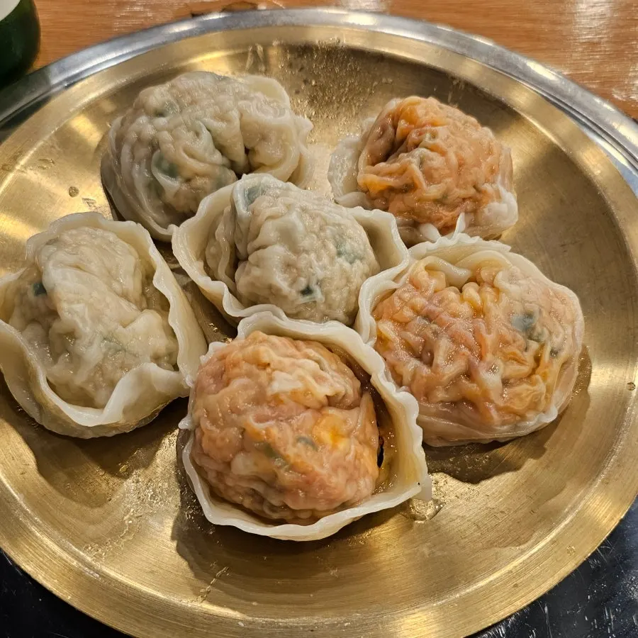 Round handmade dumplings sitting in the broth