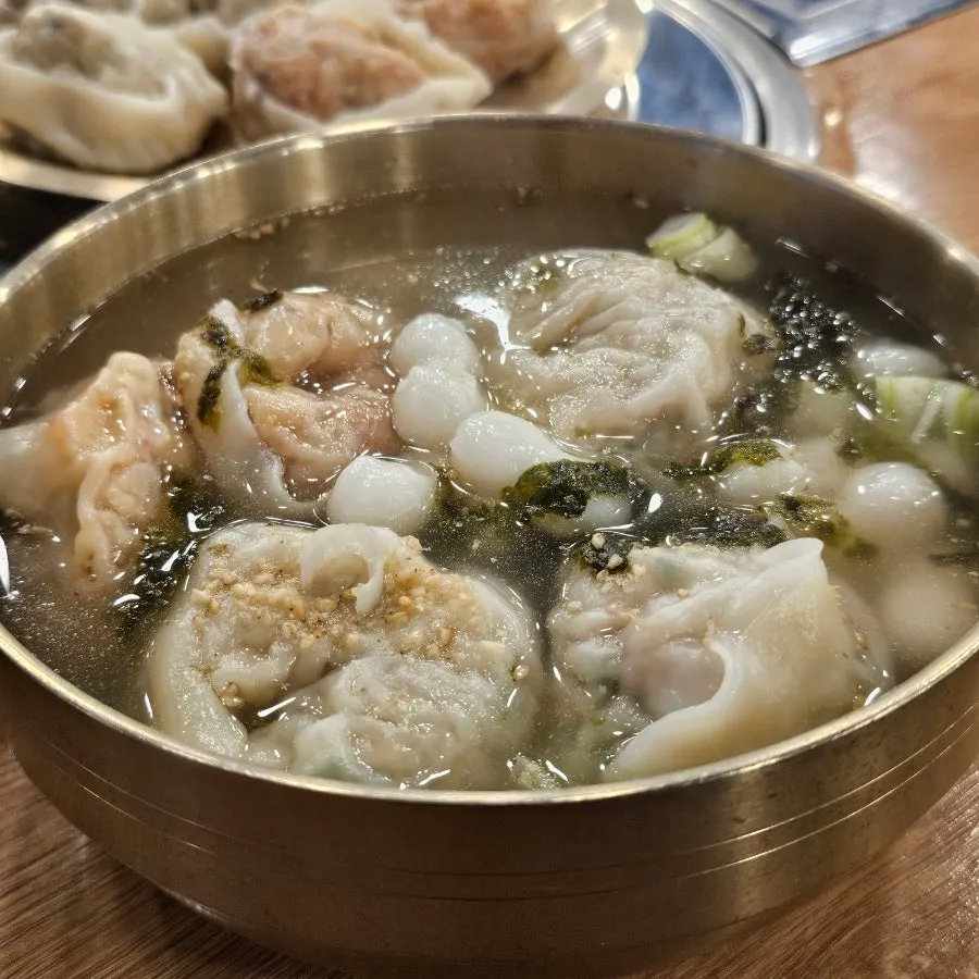 Ladle scooping up dumplings and broth
