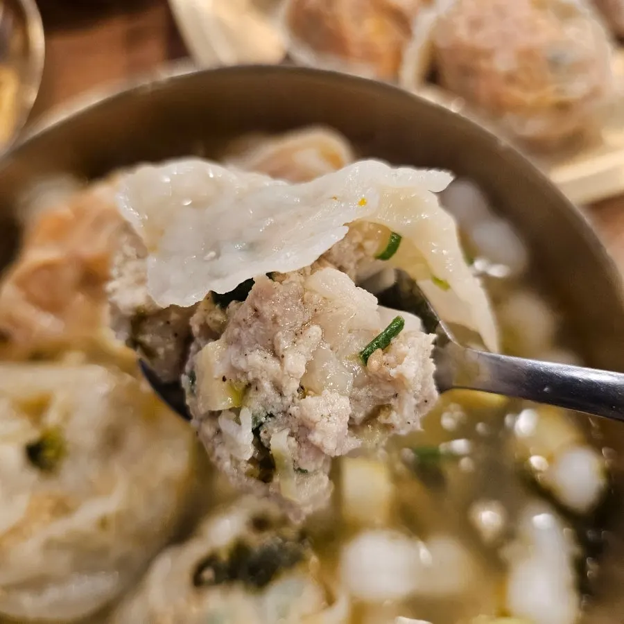 Meat dumpling and kimchi dumpling cut in half to show the filling