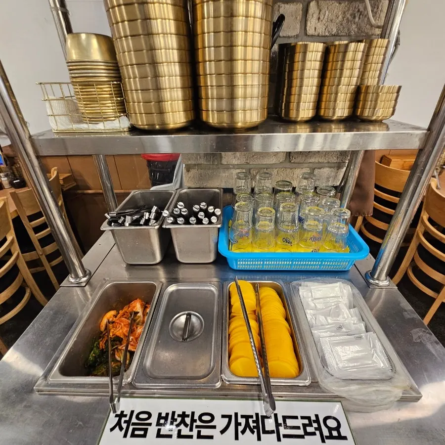 Table spread with beer and soju alongside the meal