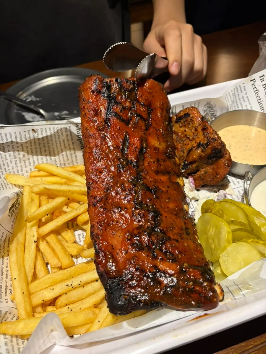 Ribs with fries, salad, and two sauces