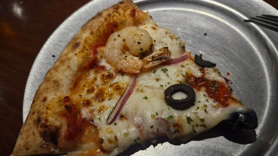 Pizza topped with shrimp and red onion