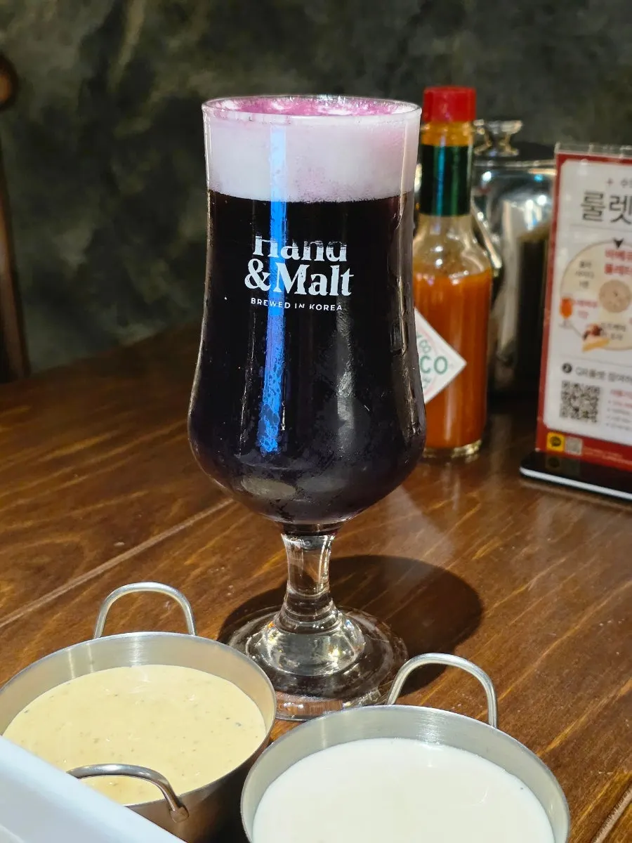 A glass of purple ube beer