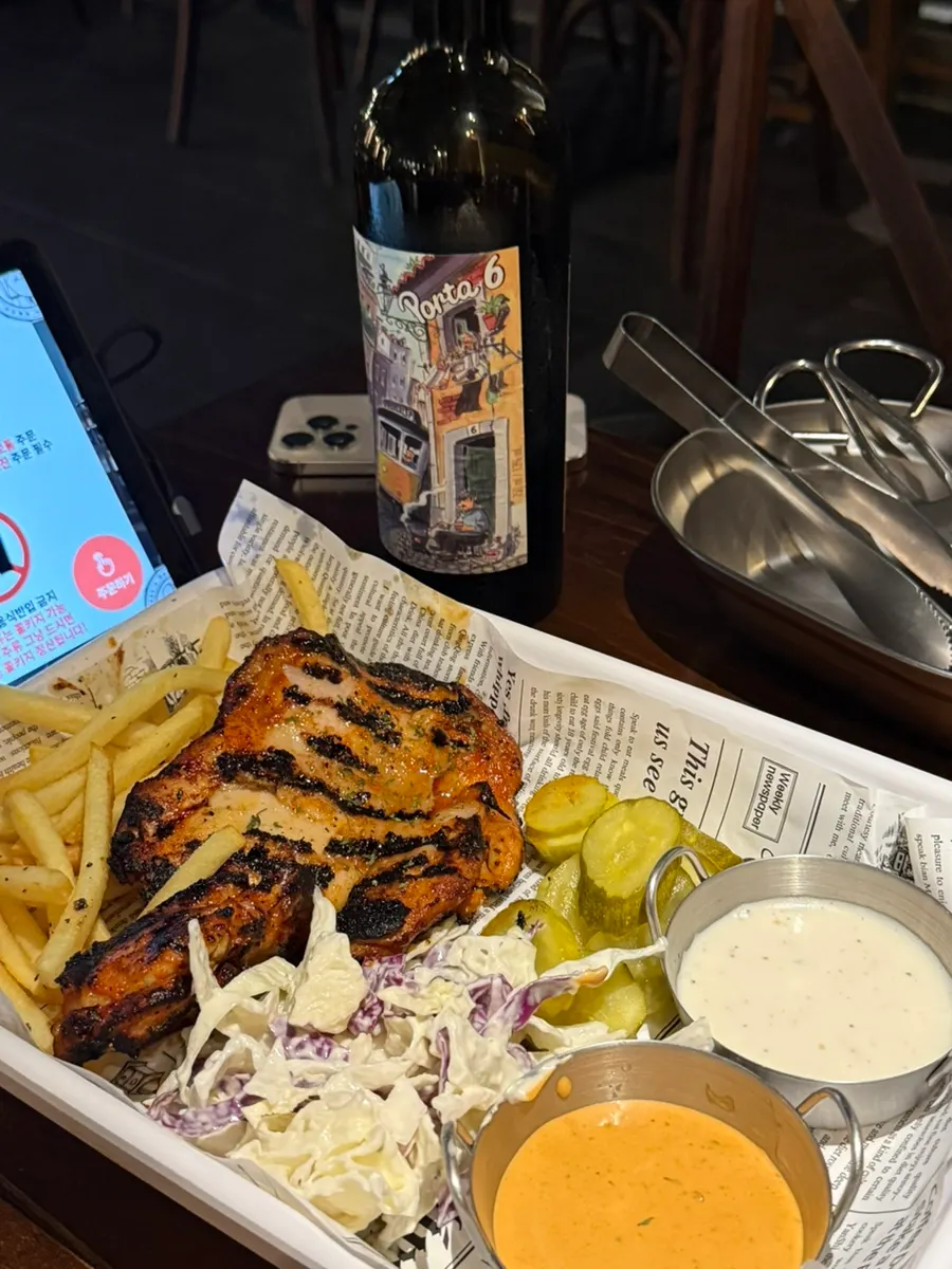 Roast chicken served with salad and fries