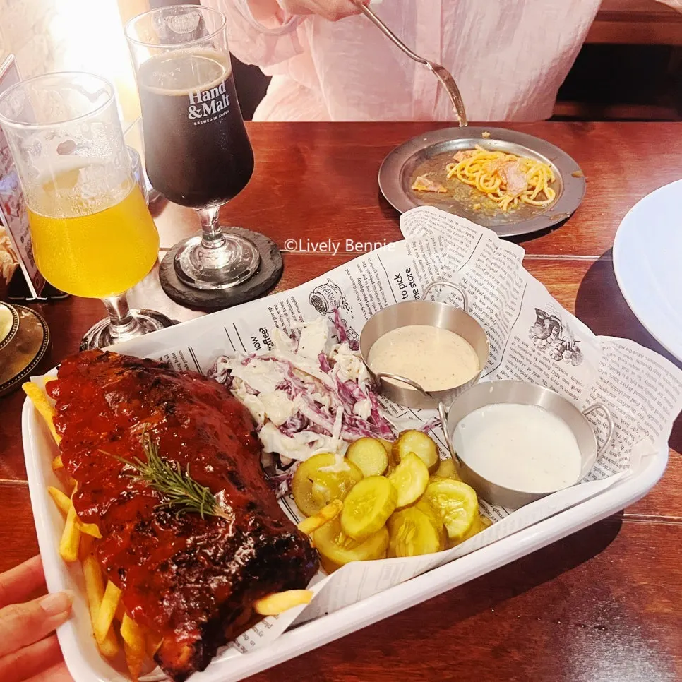 A spread of ribs, rosé pasta, and craft beer