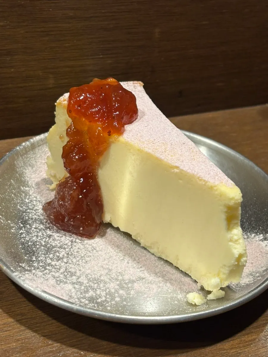 Cross-section of cheese cake dusted with ube powder
