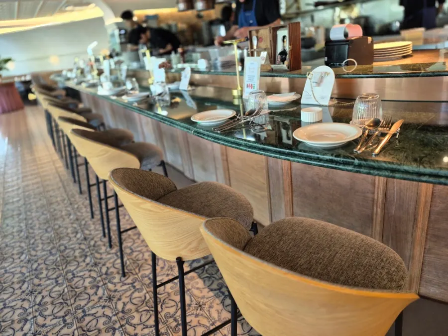 BAR seats facing the open kitchen
