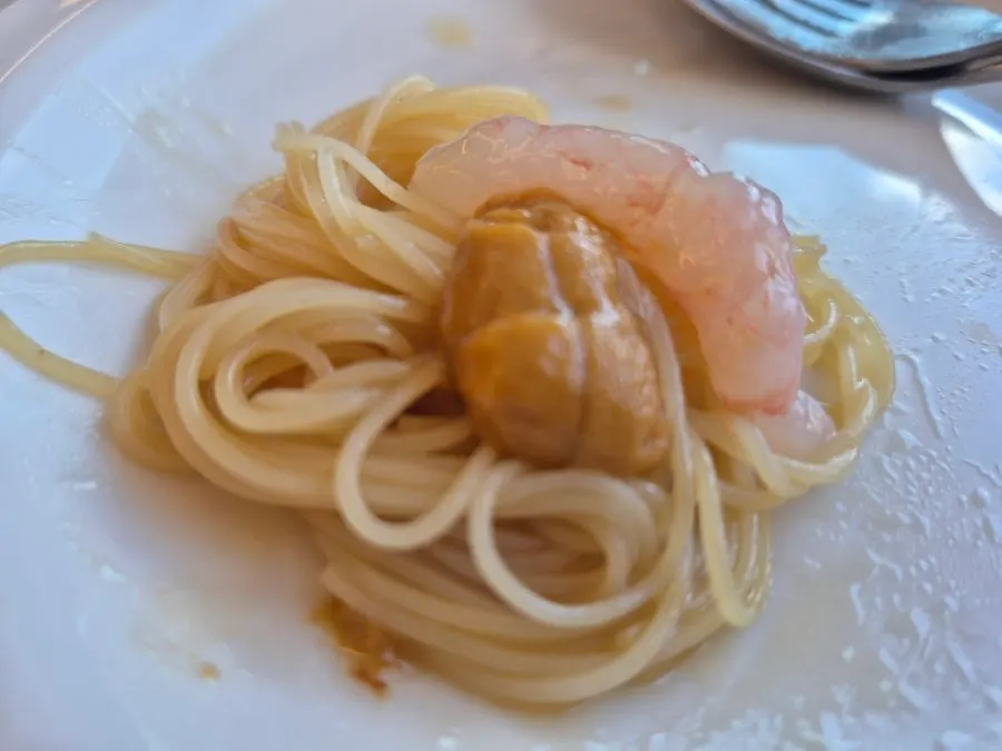 Close-up of capellini topped with sea urchin and sweet shrimp