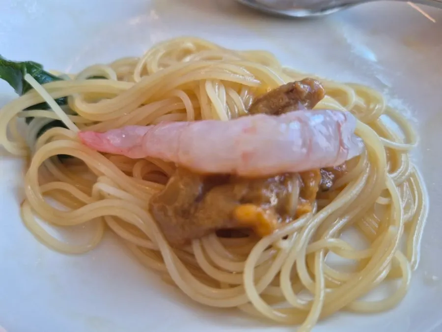 Sea urchin pasta topped with water celery and dill
