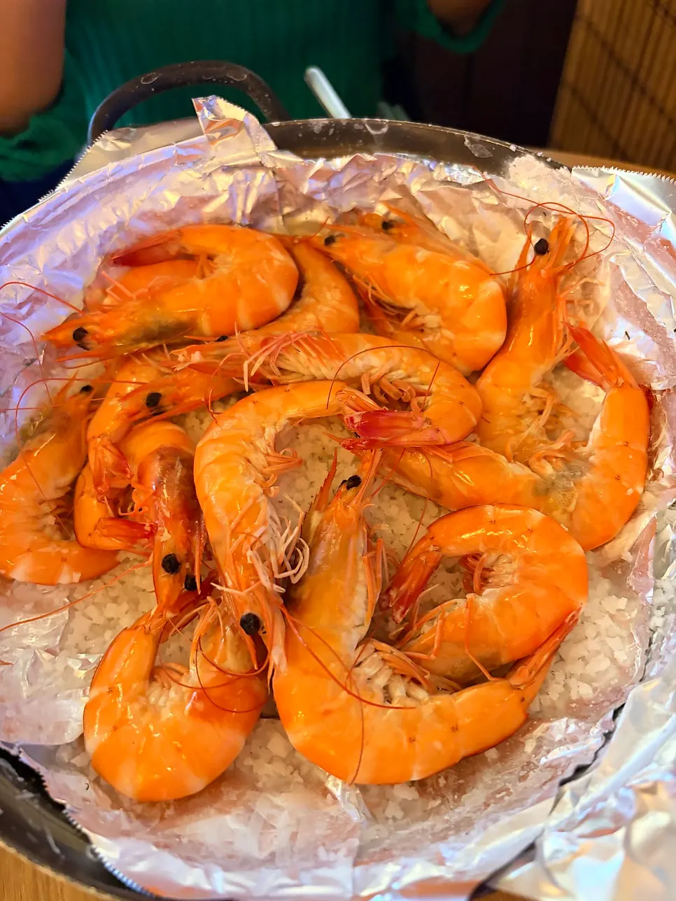 Table with grilled jumbo shrimp and drinks