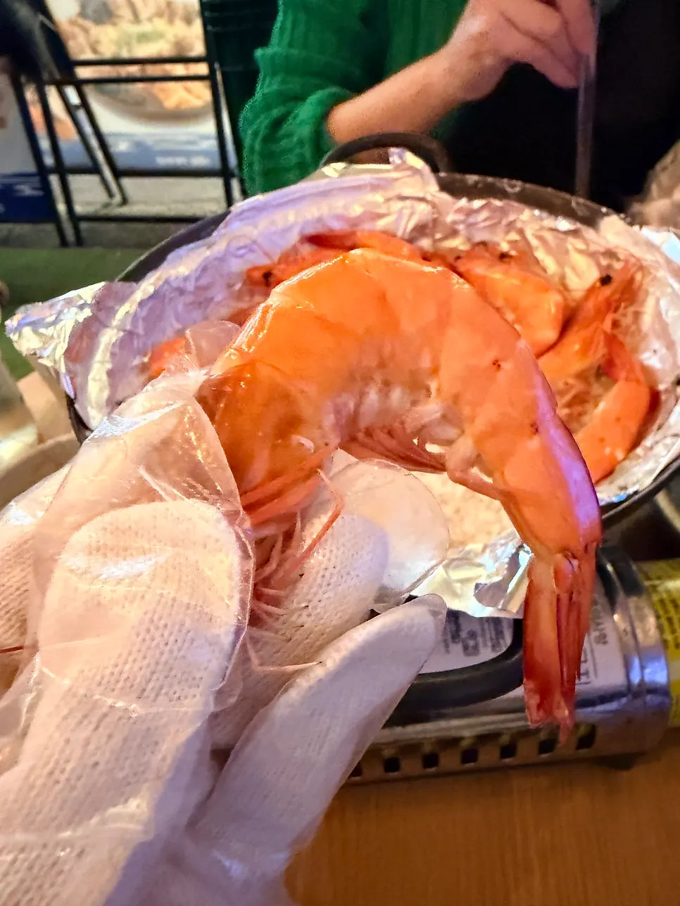 Table with leftover jumbo shrimp and glasses