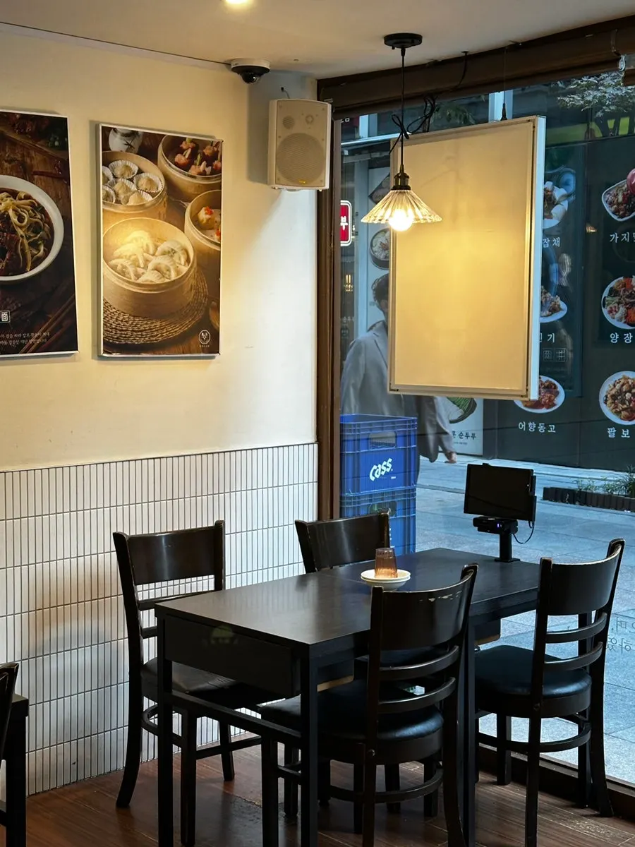 In-store menu board listing uyuk dosakmyeon and dim sum