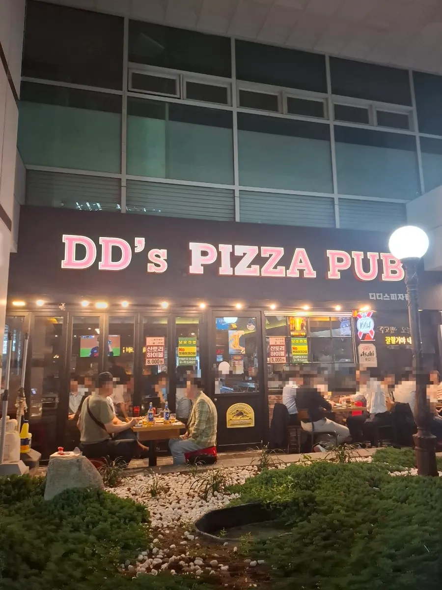 Handmade-dough pizza next to a beer glass