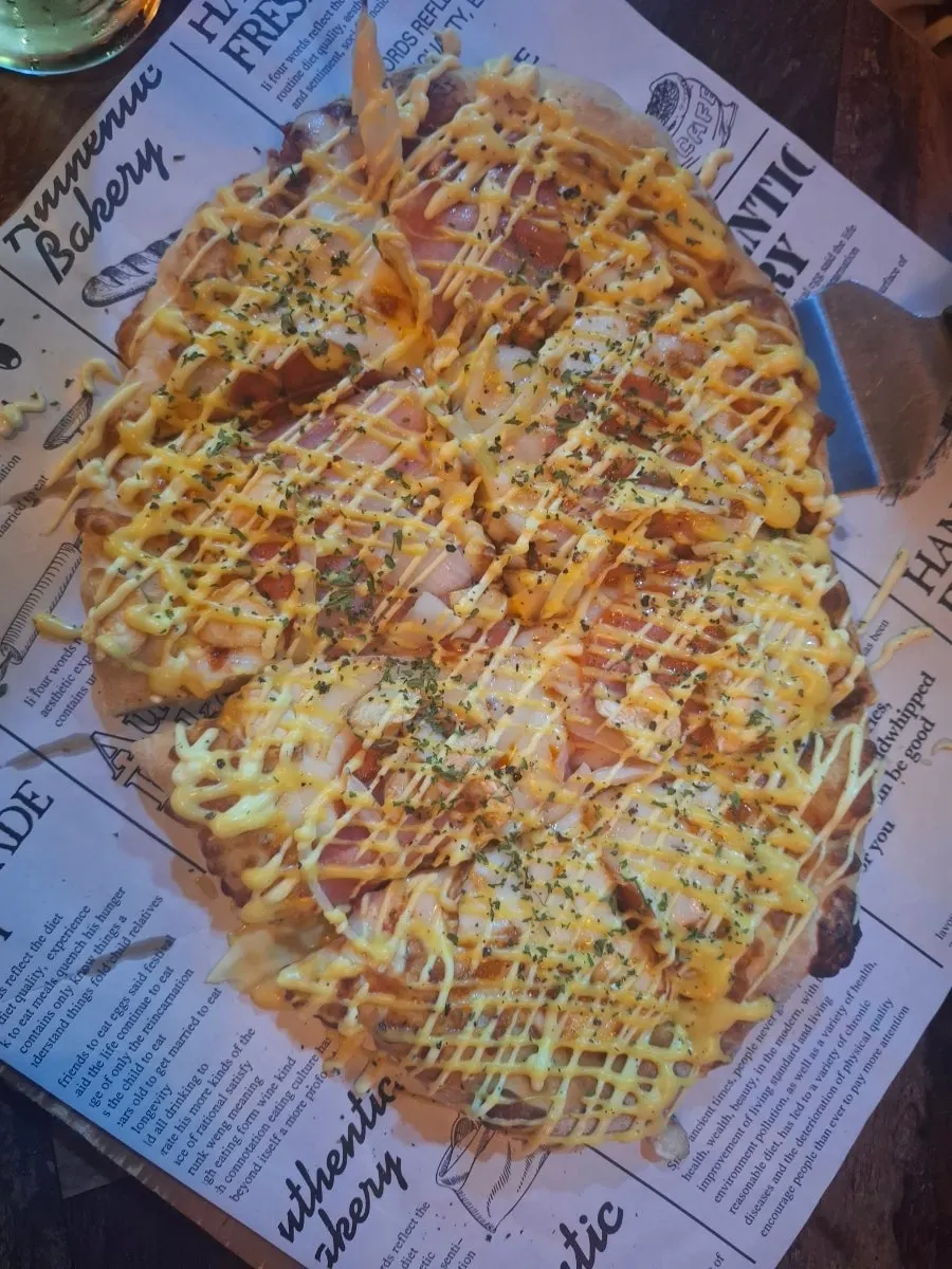 A spicy slice of buldak pizza topped with cheongyang chili
