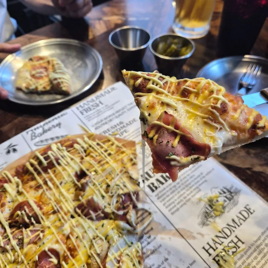 Cross-section of pizza showing bacon and cheese