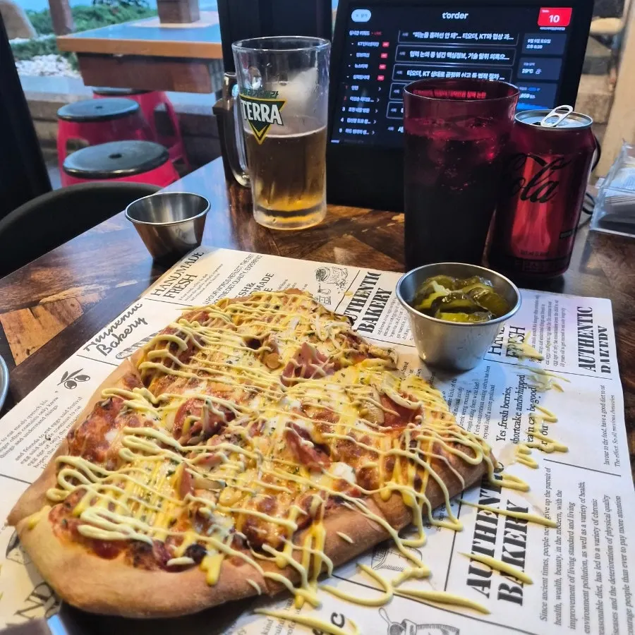 A slice of garlic sauce pizza eaten by hand