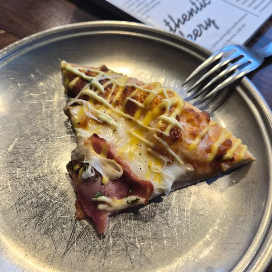A large slice of pizza cut generously