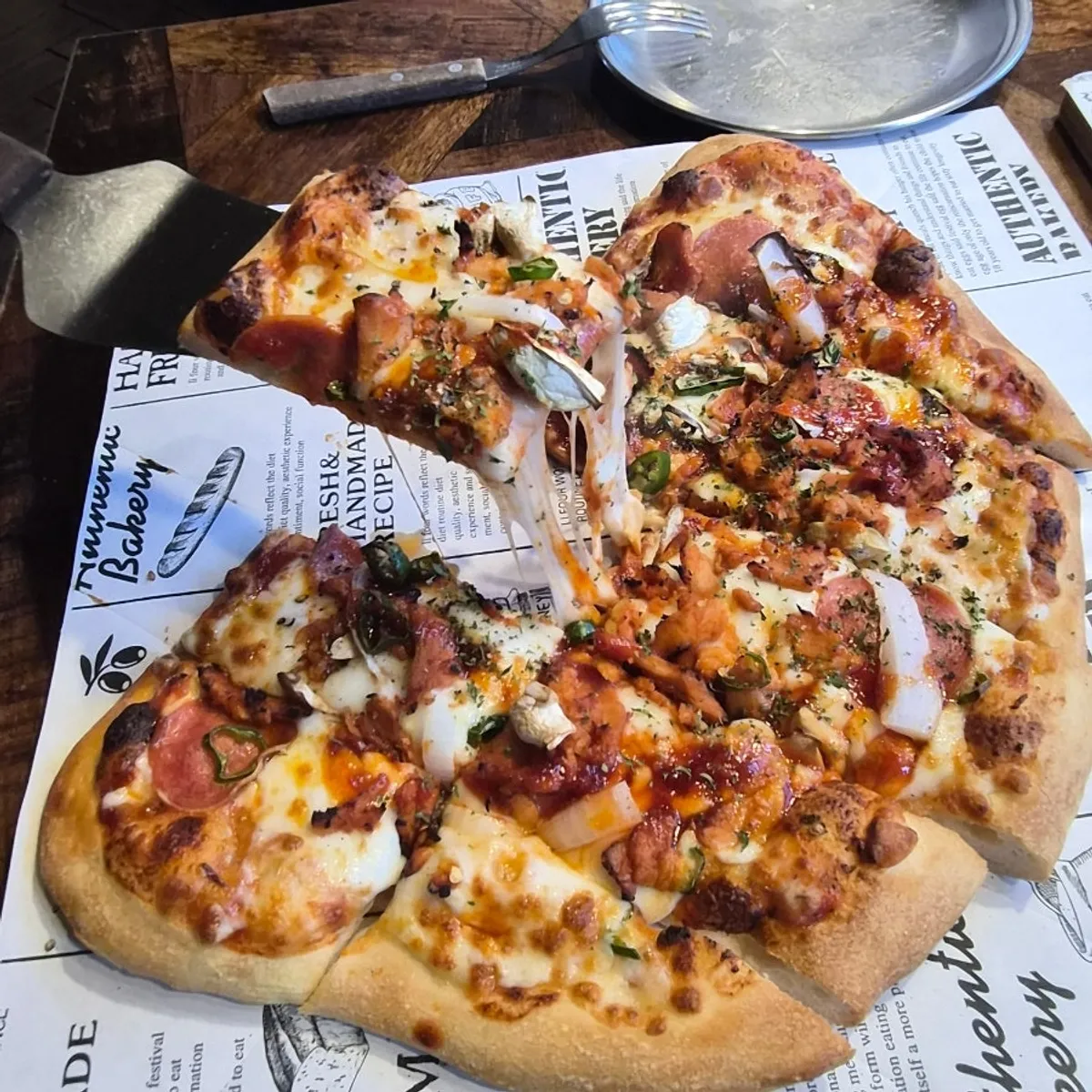 A pizza slice with stretchy melted cheese