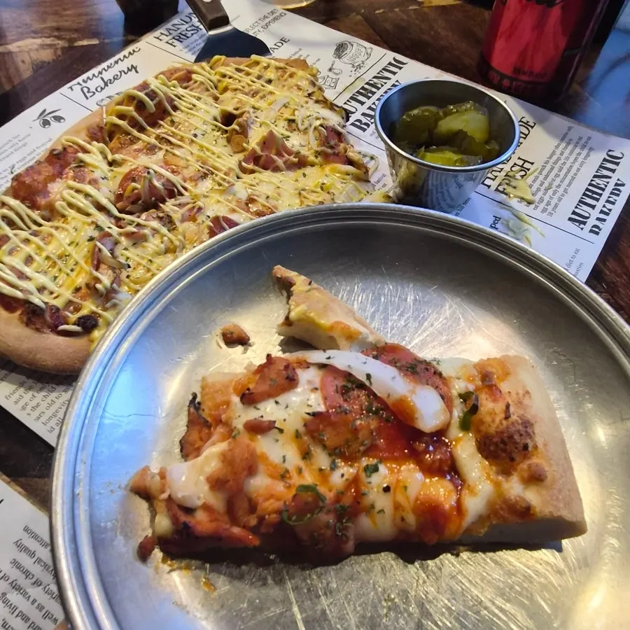 Fire chicken pizza topped with parmesan cheese