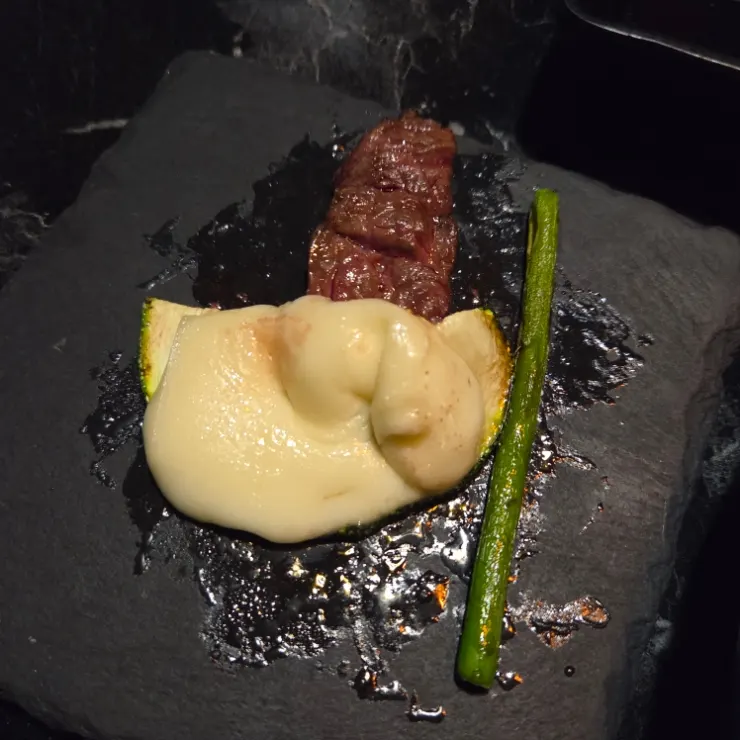 Meat paired with squash, cheese and asparagus