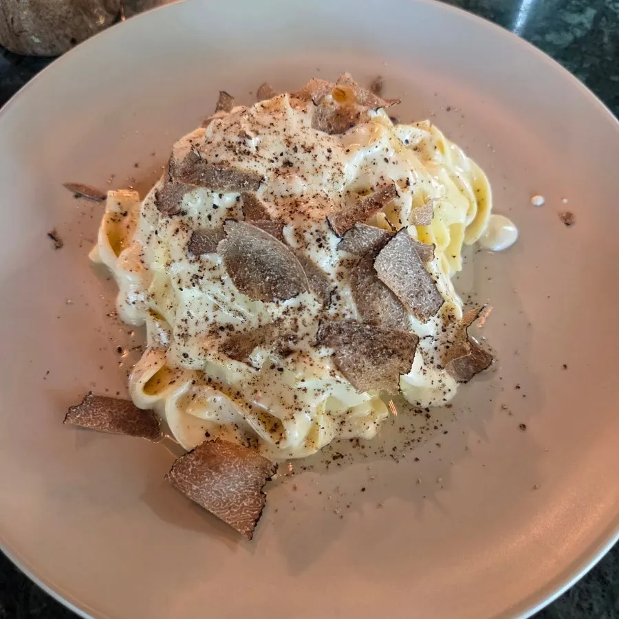 Truffle cheese-wheel tagliatelle