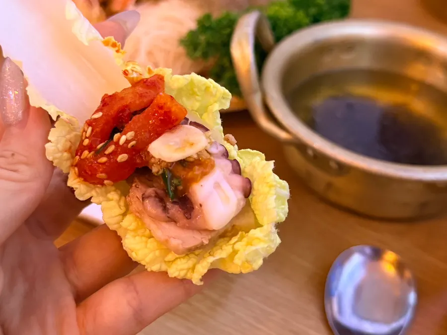 Octopus bossam wrapped with white kimchi and vegetables