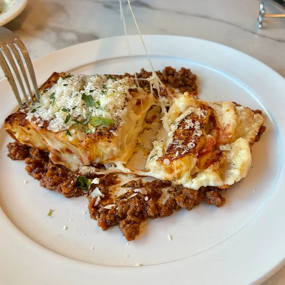 A cut cross-section of the lasagna served on a plate