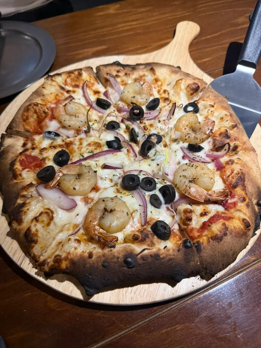 Seafood pizza topped with shrimp