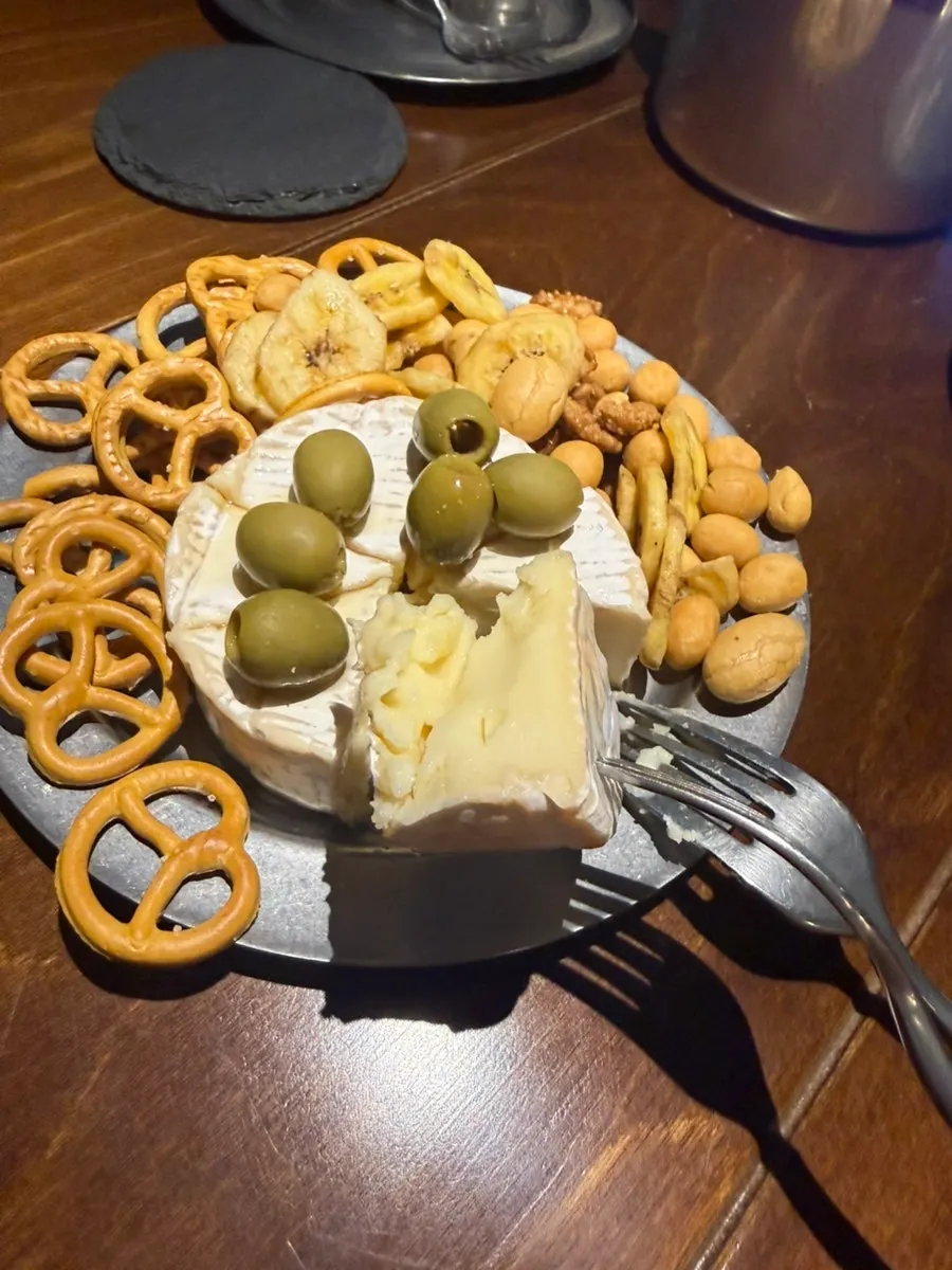 Brie cheese plate eaten alongside the pizza