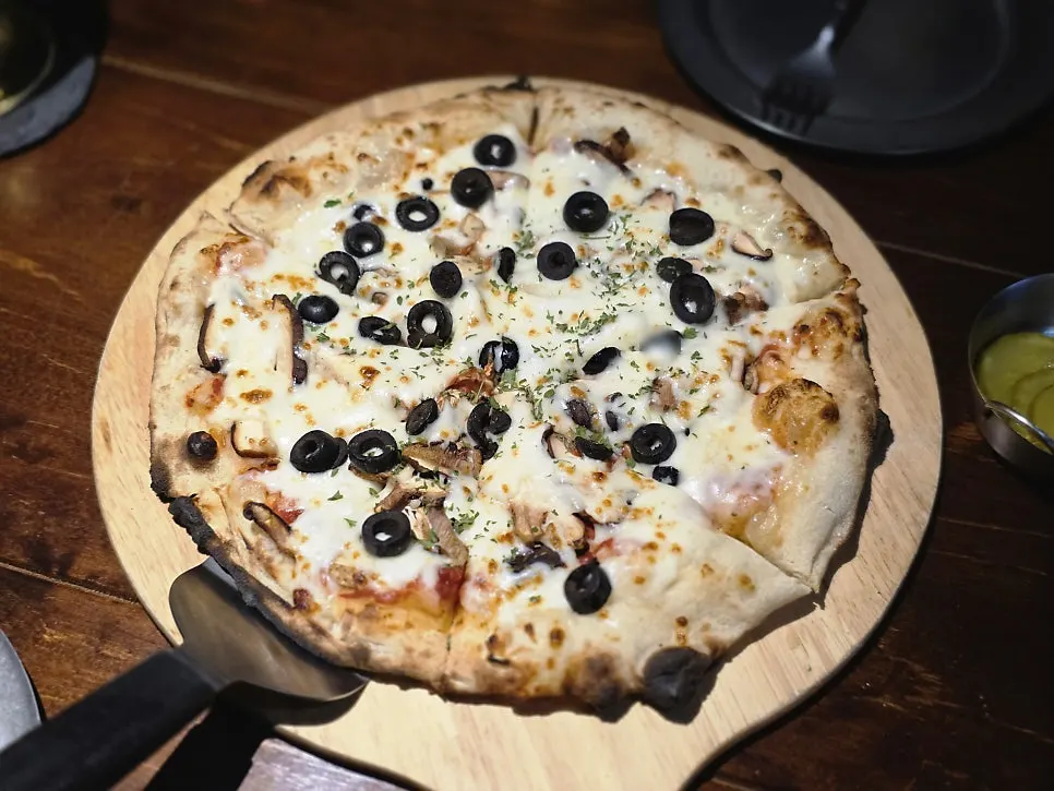 Freshly served monk's fragrant fungi pizza