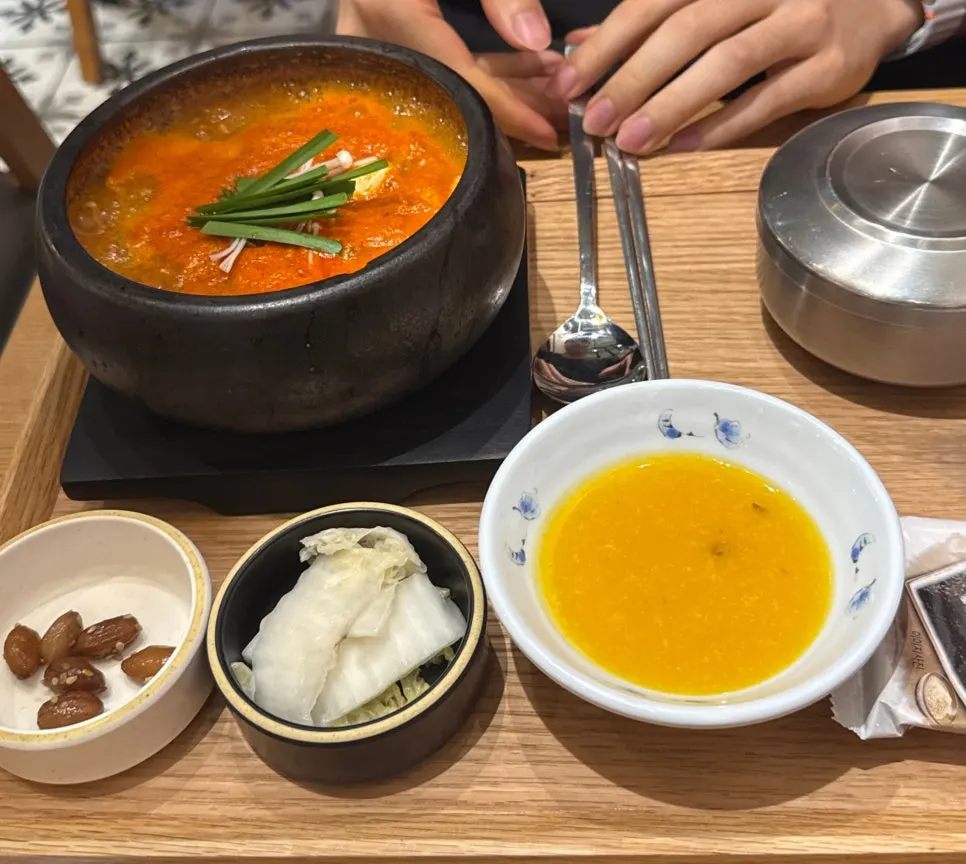 Stone pot of spicy seafood soft tofu stew topped with chives