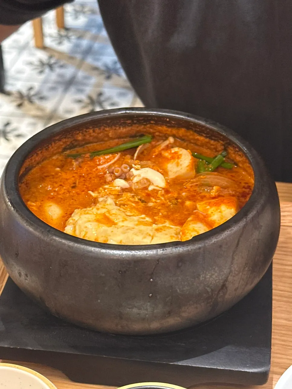 A spoonful of large soft tofu chunks