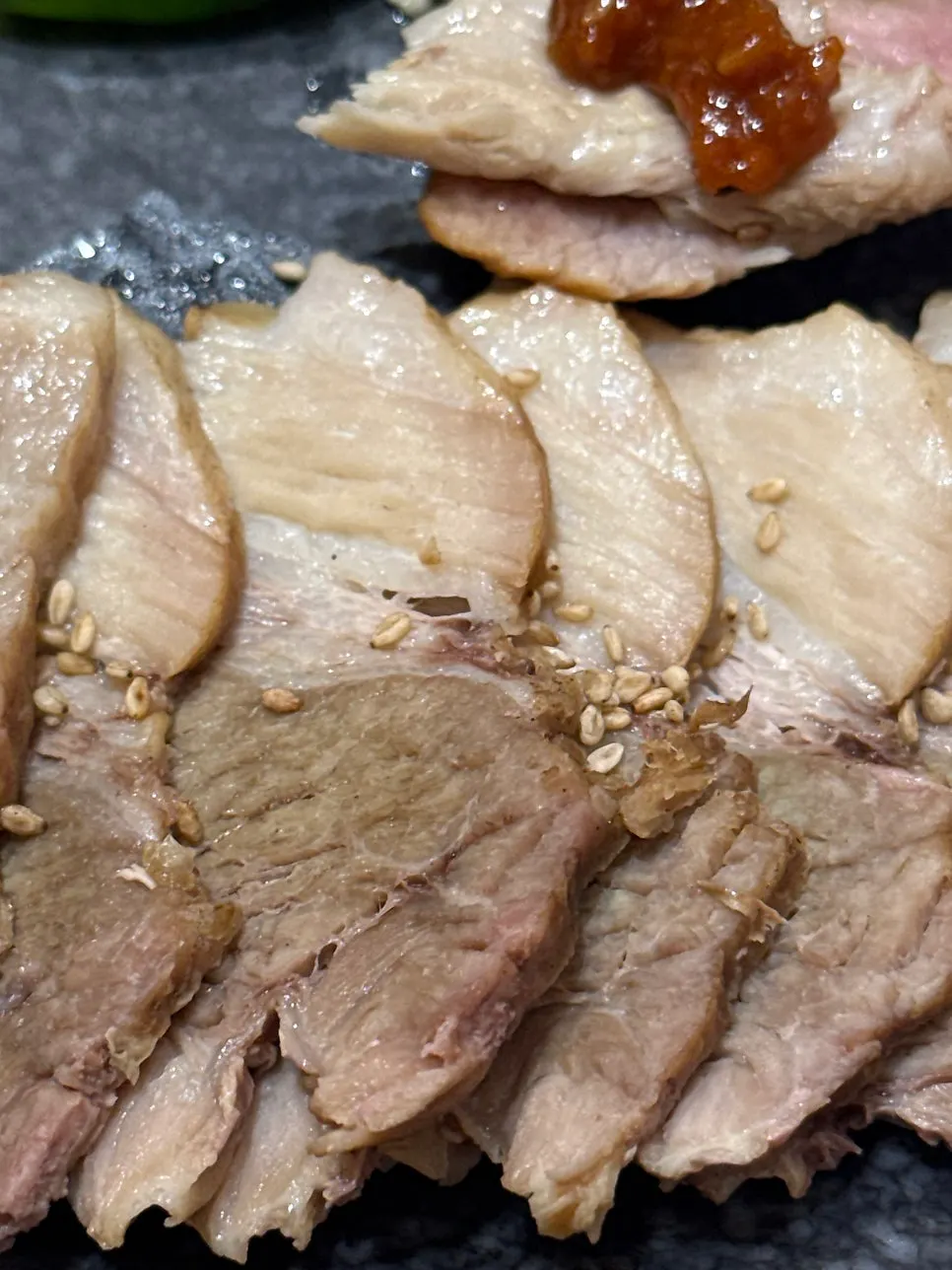 Boiled pork slices neatly arranged on a plate