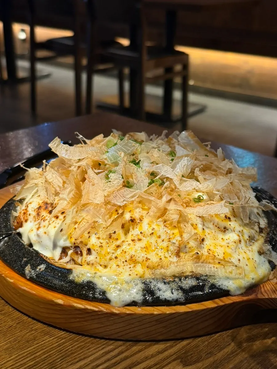 A plate of cheese okonomiyaki