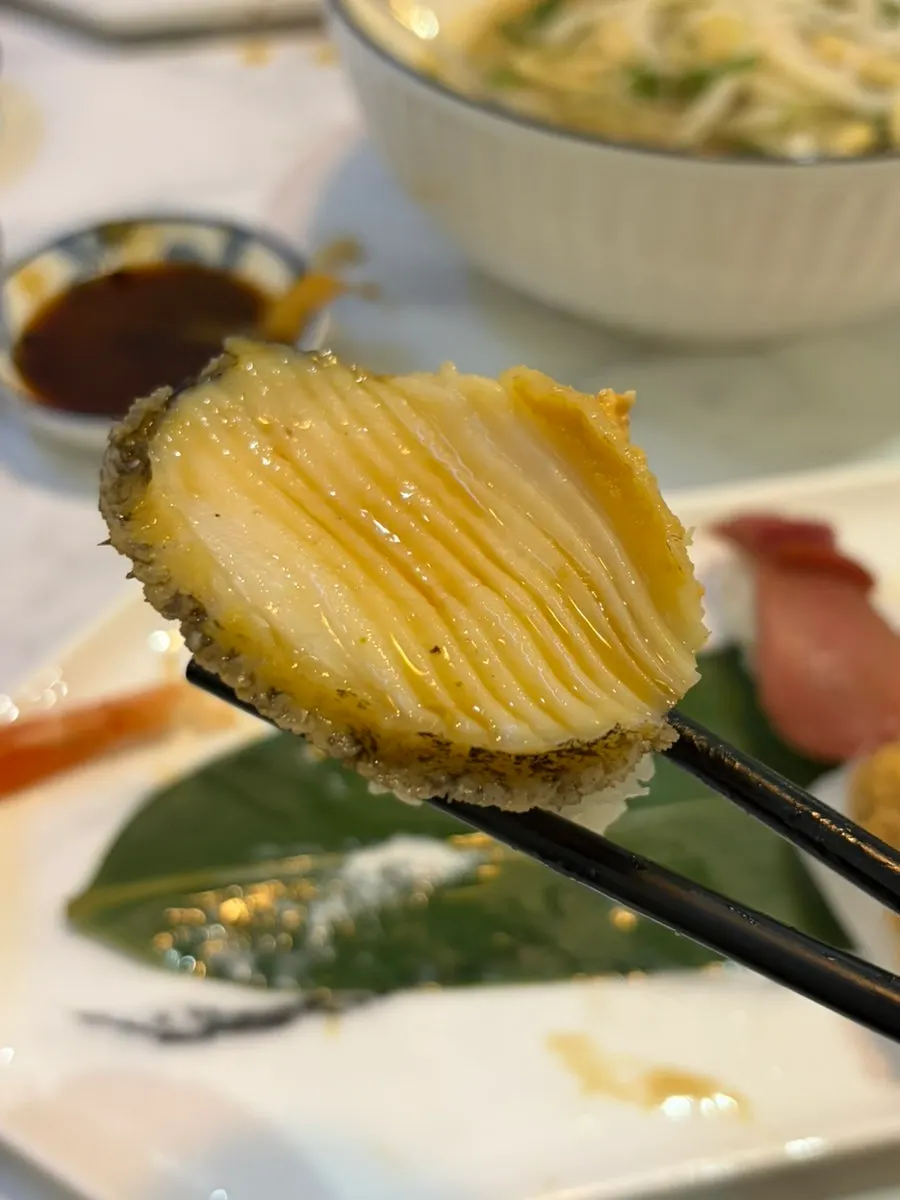 Finely scored abalone sushi