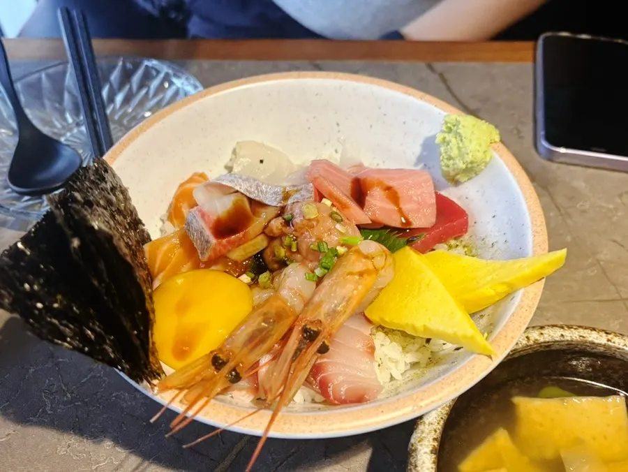 Sashimi dipped in egg yolk mixed with soy sauce