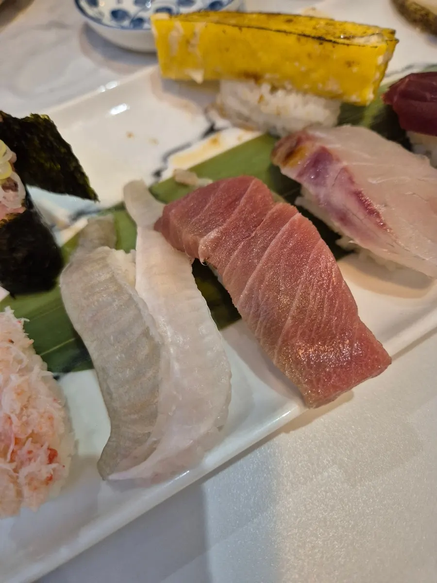 Close-up of sushi topped with thick fish slices