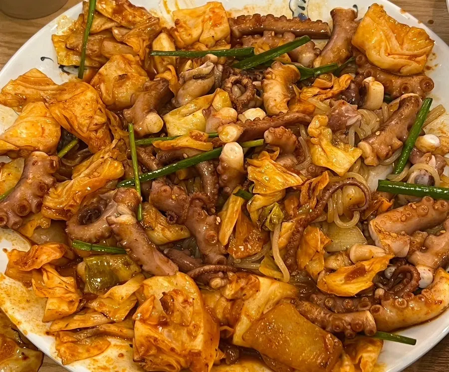 Octopus stir-fry with a generous bed of cabbage and onion