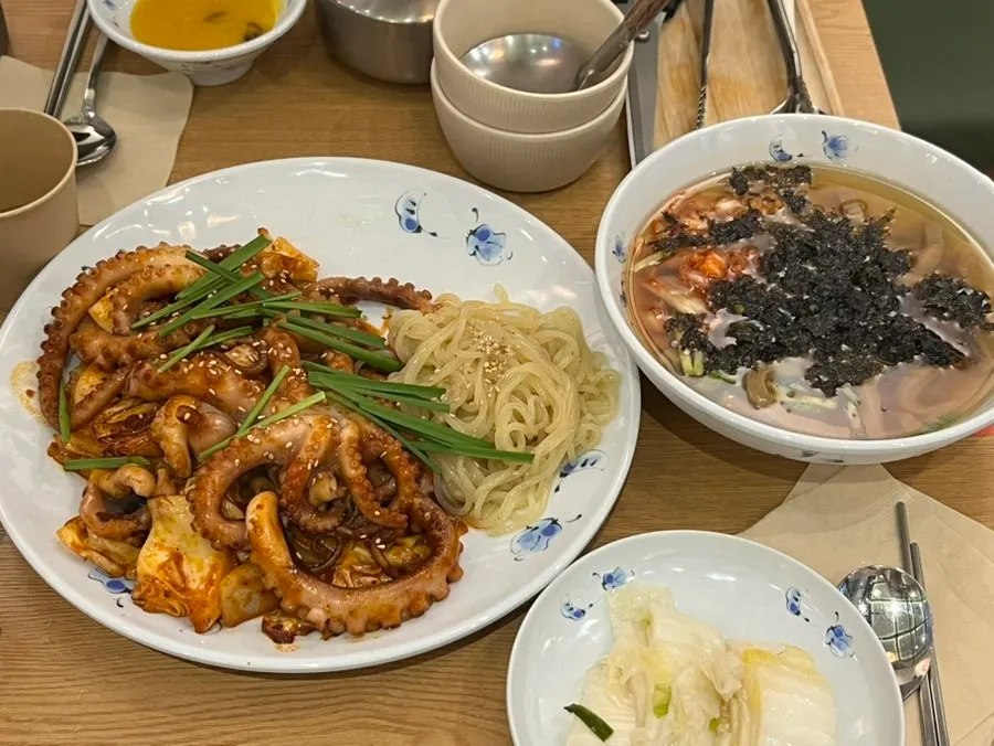 Full lunch table for two with the whole octopus stir-fry and side dishes